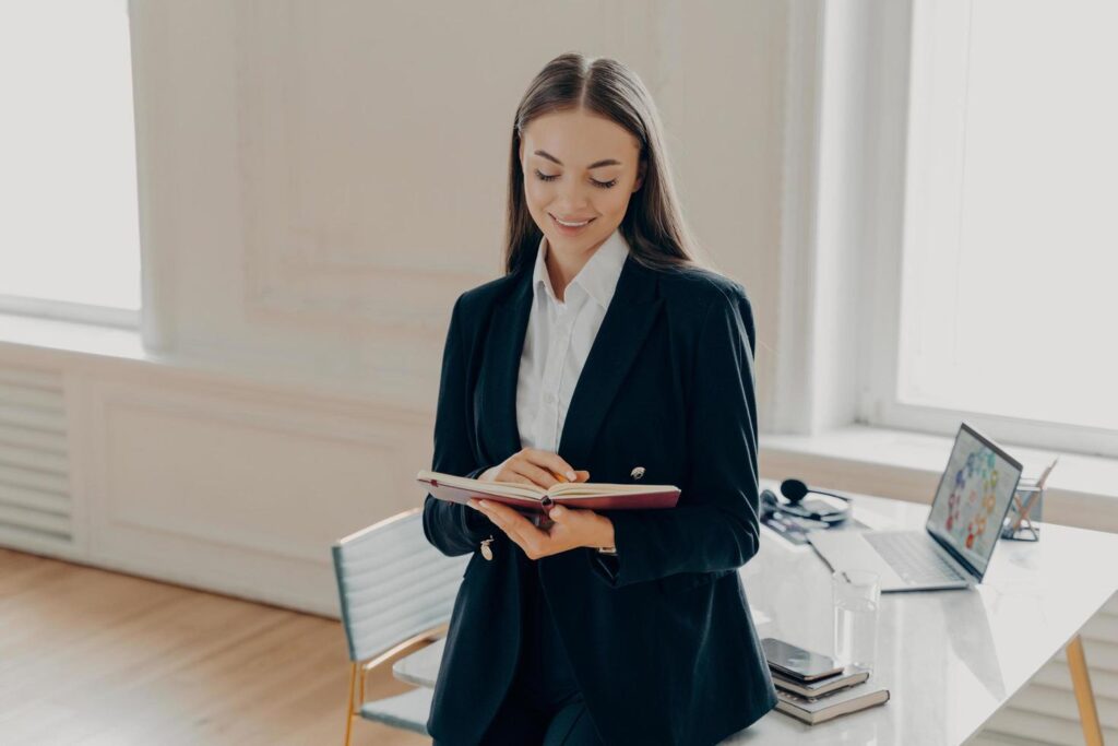 mom business owner writing down vision and goals for 2025